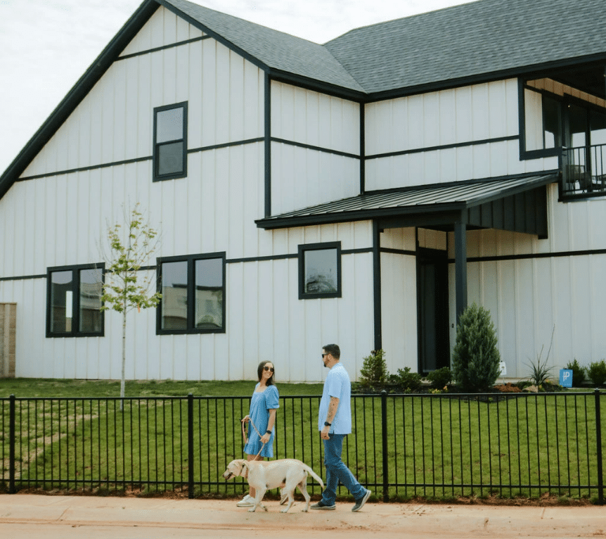 Couple walking dog outside of TimberCraft home