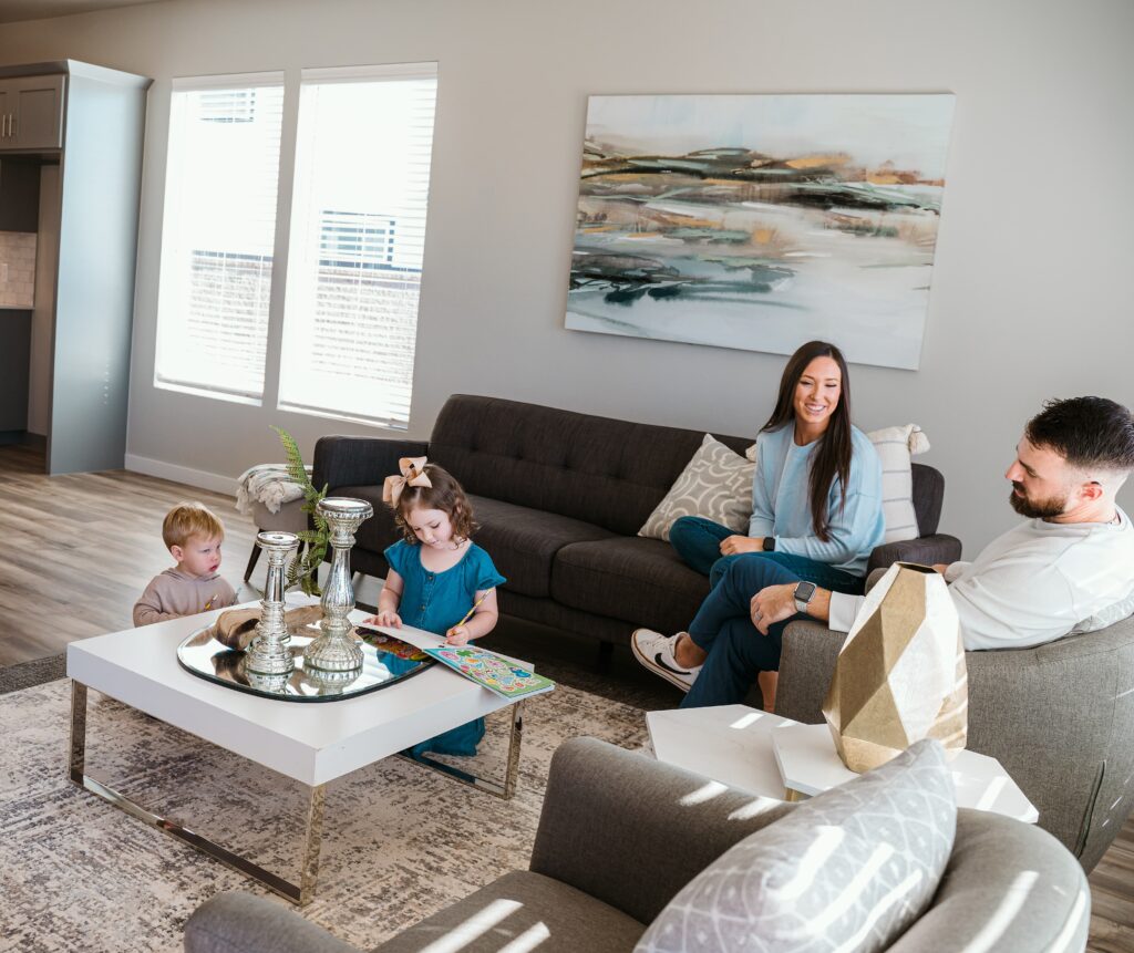 Family relaxing in the living room of a TimberCraft home