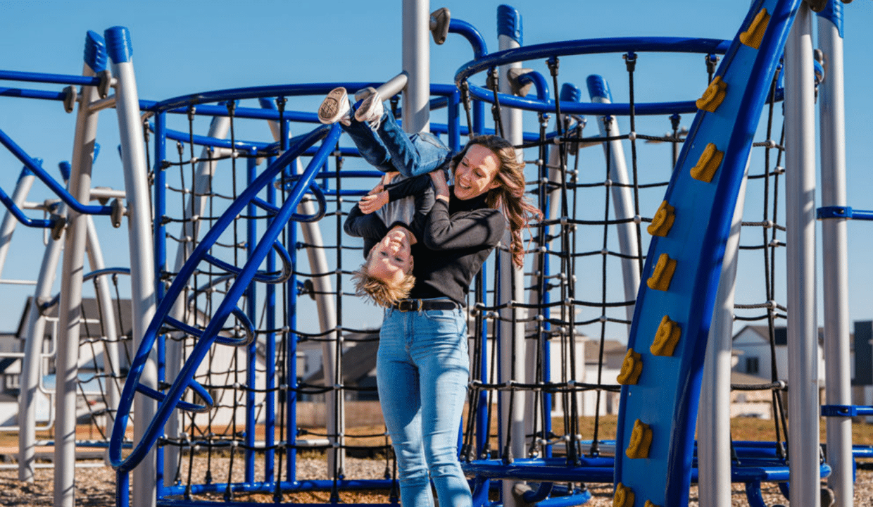 Mother playing with her son at a TimberCraft playground