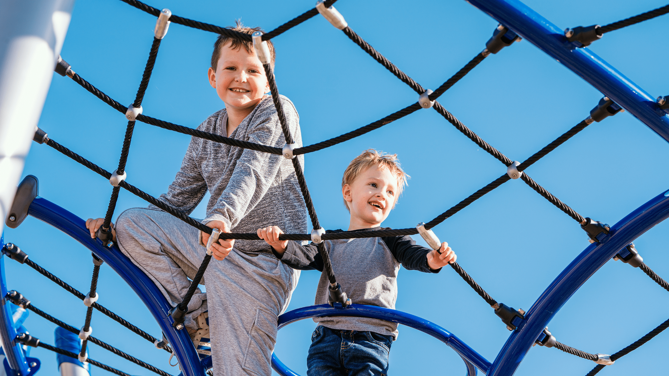 Kids playing in a TimberCraft community playground